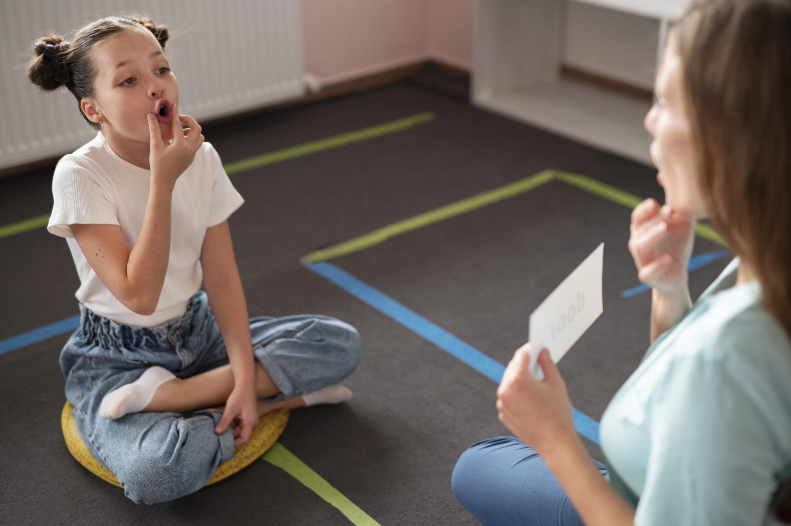 psychologist-helping-little-girl-speech-therapy-indoors